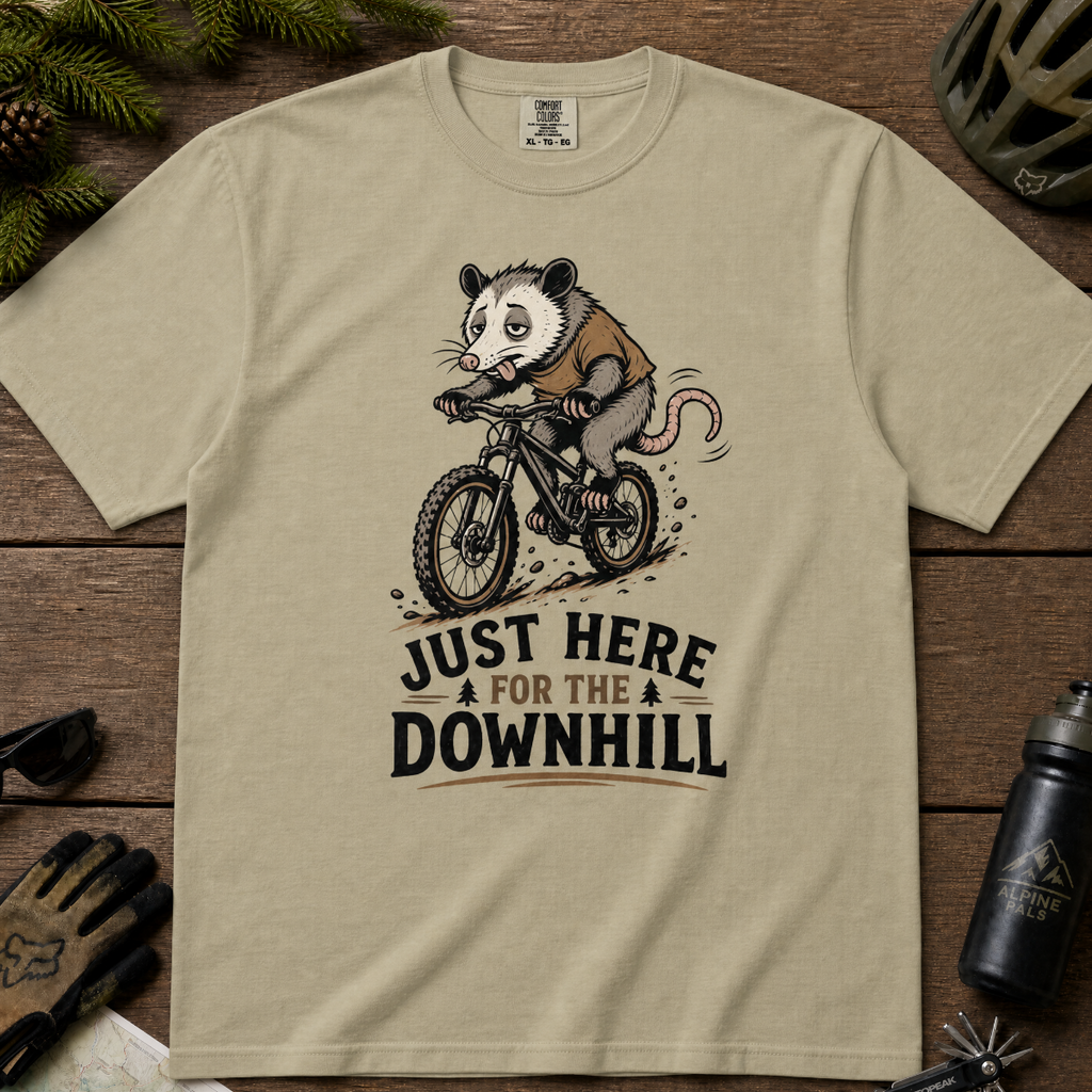 Khaki colored t-shirt with an opossum riding a bike graphic and text 'Just Here for the Downhill'.