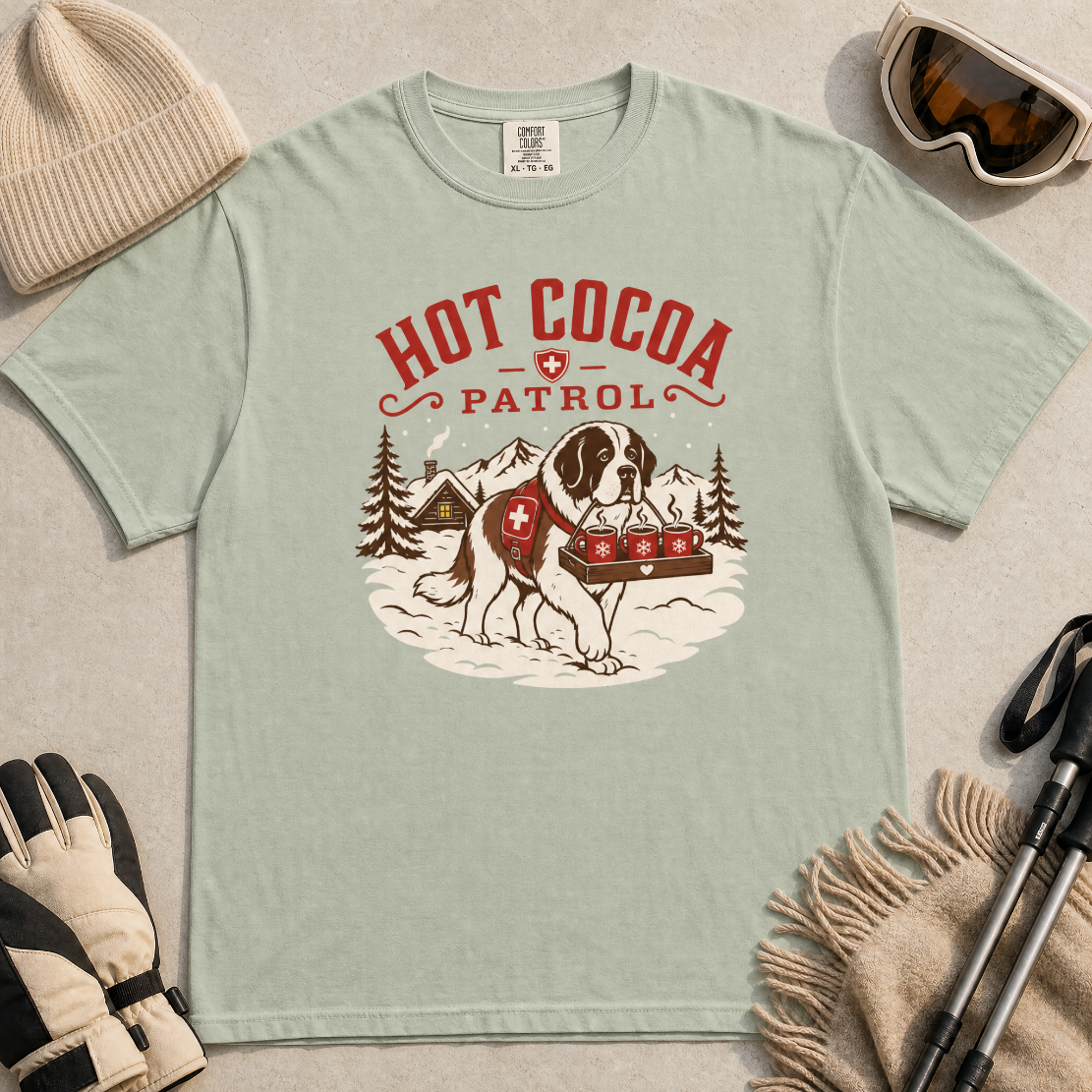 Bay green t-shirt with a graphic of a dog and 'Hot Cocoa Patrol' text.