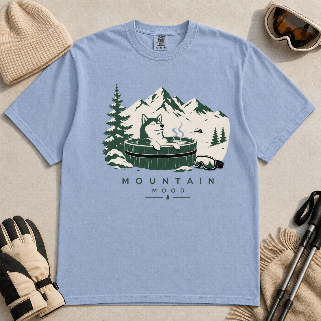 Washed denim blue t-shirt with a graphic of a husky in a hot tub surrounded by mountains and trees.