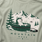Bay green t-shirt with a graphic of a husky in a hot tub surrounded by mountains and trees.