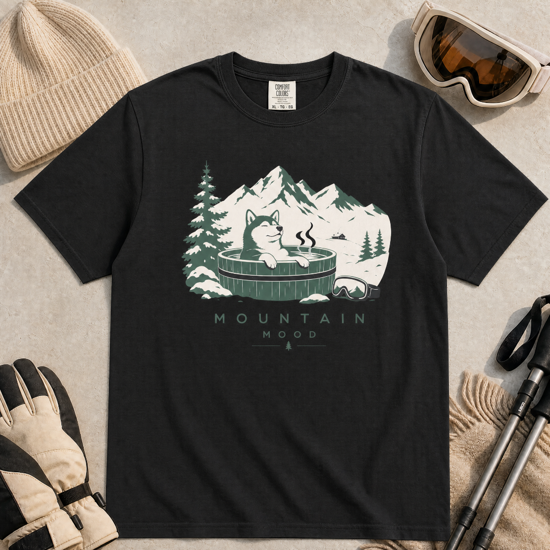 Black t-shirt with a graphic of a husky in a hot tub surrounded by mountains and trees.