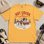 Mustard yellow t-shirt with a graphic of a dog and 'Hot Cocoa Patrol' text.