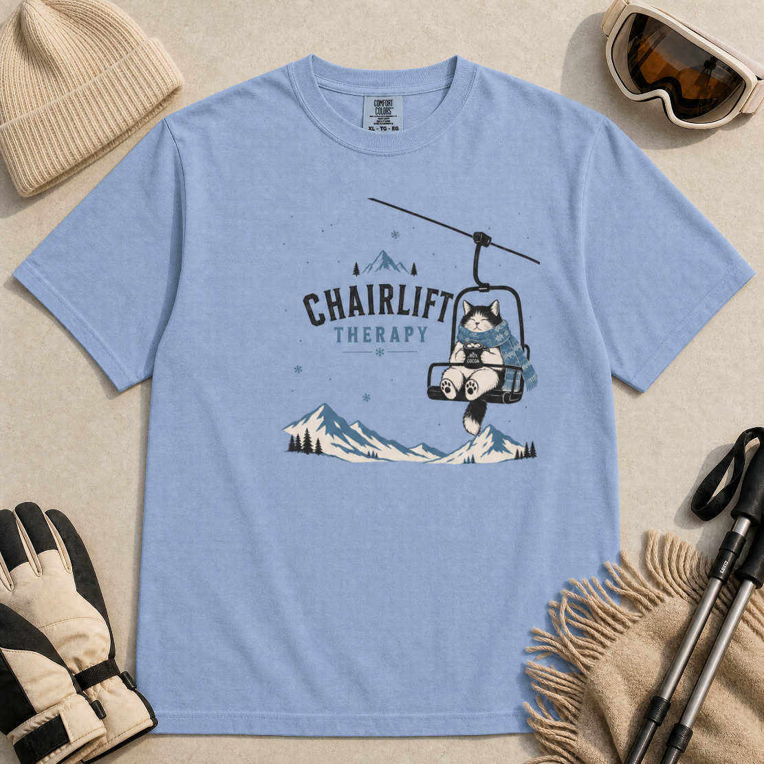 Washed denim blue t-shirt with 'Chairlift Therapy' graphic design.