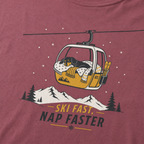 Brick red t-shirt with a graphic of a dog in a gondola lift and text 'Ski Fast Nap Faster'.