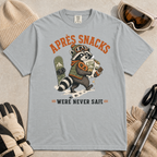 Granite gray t-shirt with a raccoon stealing snacks graphic and "Après Snacks Were Never Safe" text.