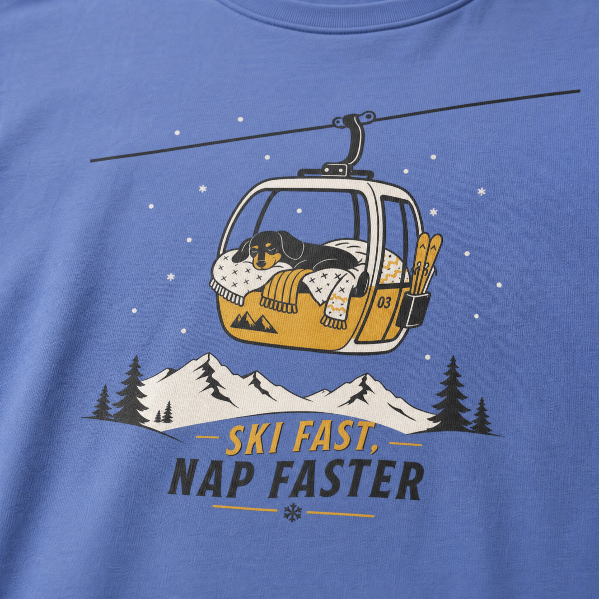 Mystic blue t-shirt with a graphic of a dog in a gondola lift and text 'Ski Fast Nap Faster'.