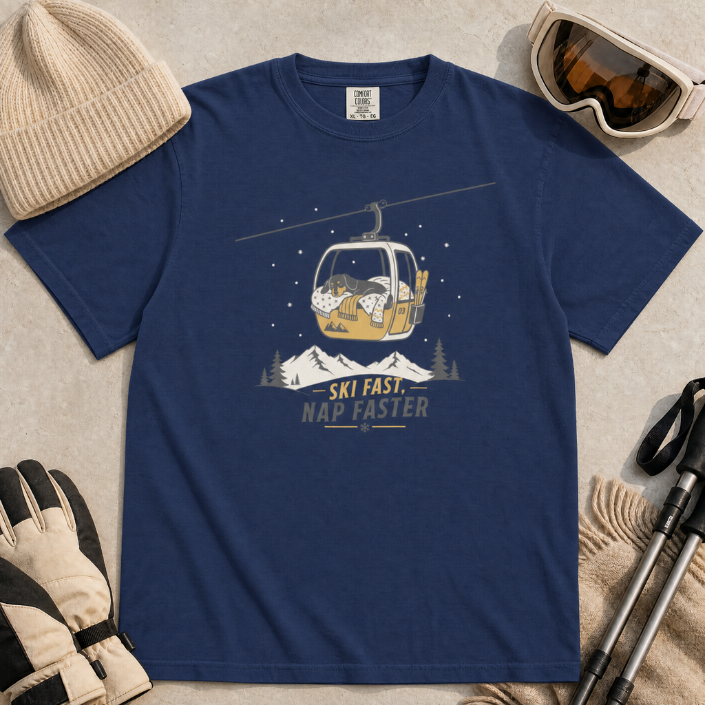 Navy blue t-shirt with a graphic of a dog in a gondola lift and text 'Ski Fast Nap Faster'.