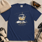 Navy blue t-shirt with a graphic of a dog in a gondola lift and text 'Ski Fast Nap Faster'.