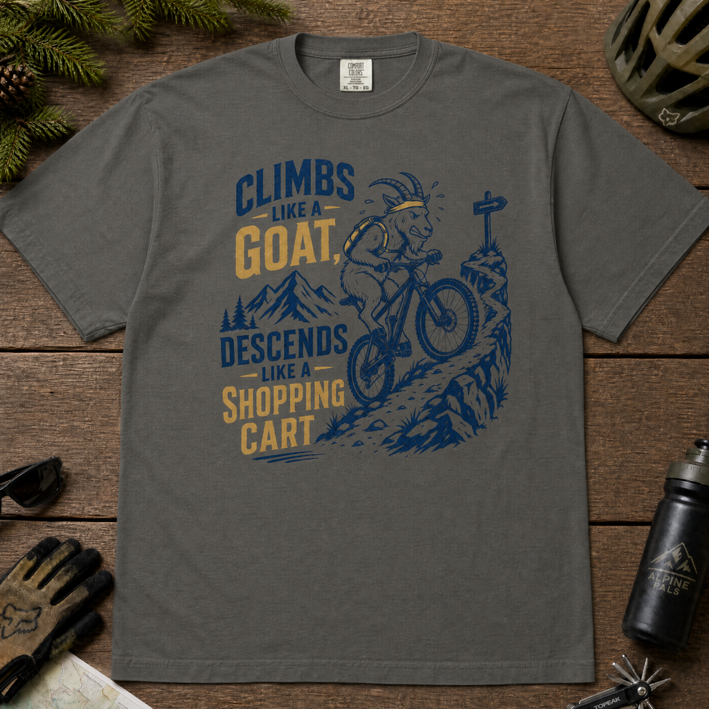 Pepper gray t-shirt with graphic design and text on a wooden surface with outdoor gear.