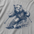 Close-up of a granite gray t-shirt with a dynamic bear skier graphic showing the bear carving through snow with goggles and ski poles.