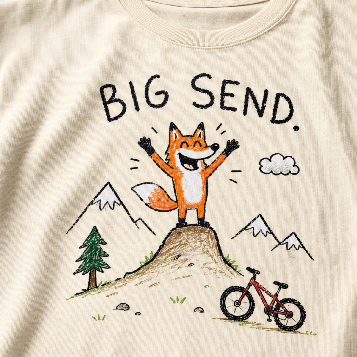 Close-up of an ivory white t-shirt with a childlike crayon-style mountain biking design showing a joyful fox standing on a dirt jump with “Big Send.” text.