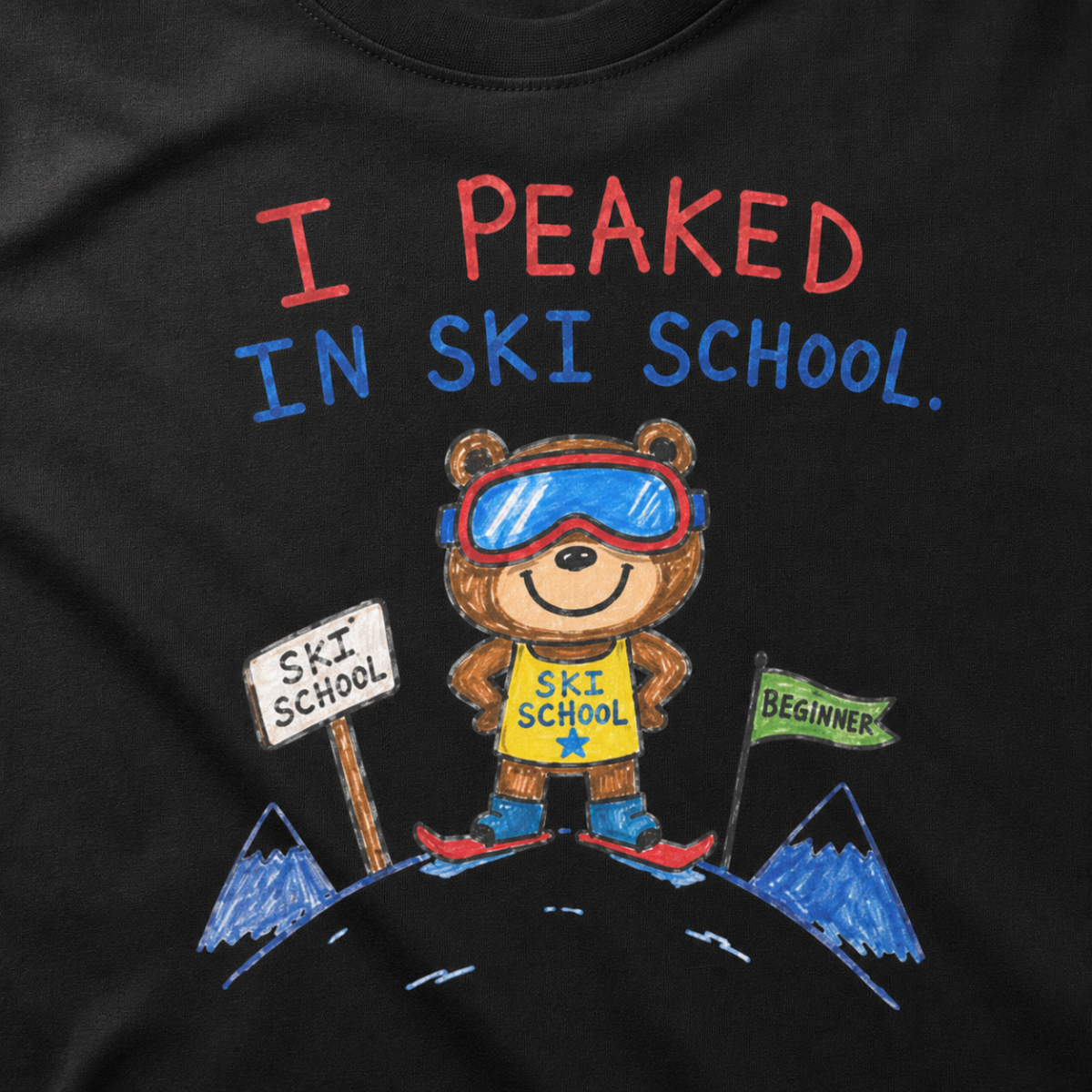 Close-up of a black t-shirt with a playful hand-drawn bear at ski school, beginner flag, mountain details, and “I Peaked in Ski School.” text.