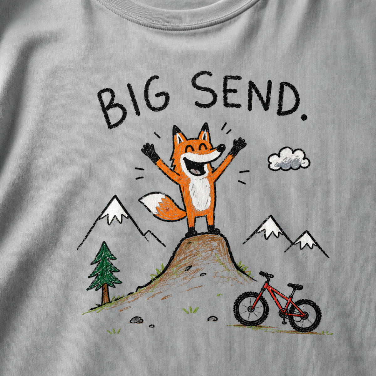 Flat lay of a granite gray t-shirt featuring a playful hand-drawn fox mountain bike graphic with mountains, a small bike, and “Big Send.” text.
