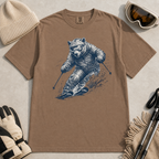 Close-up of a espresso brown t-shirt with a dynamic bear skier graphic showing the bear carving through snow with goggles and ski poles.