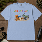 Flat lay of a washed denim blue t-shirt featuring a humorous squirrel mountain bike crash design with an upside-down “Is My Bike OK?” message.