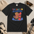 Flat lay of a black t-shirt with a playful beaver snowboarding design showing the animal chewing a board beneath “This Counts as Carving” text.