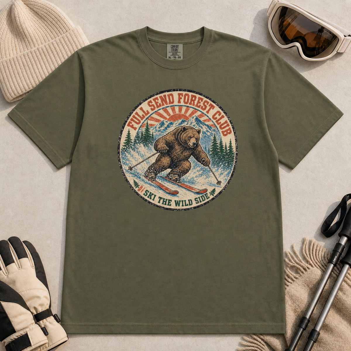 Hemp green t-shirt featuring a vintage ski bear carving through powder beneath “Full Send Forest Club” and “Ski the Wild Side” text.