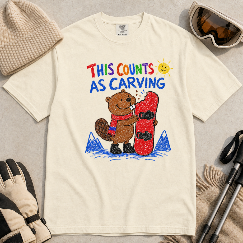 Flat lay of an ivory white t-shirt with a playful beaver snowboarding design showing the animal chewing a board beneath “This Counts as Carving” text.