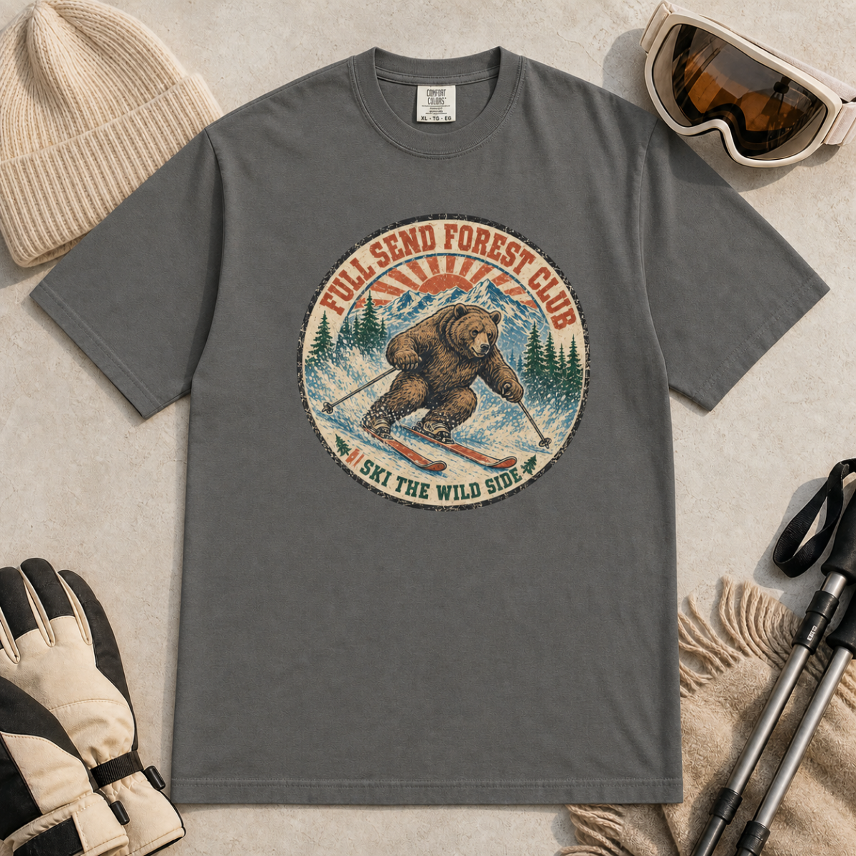 Pepper gray t-shirt featuring a vintage ski bear carving through powder beneath “Full Send Forest Club” and “Ski the Wild Side” text.