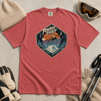 Crimson red t-shirt featuring a distressed retro fox snowboarder jumping over a snowy mountain beneath “Powder Thief” lettering.