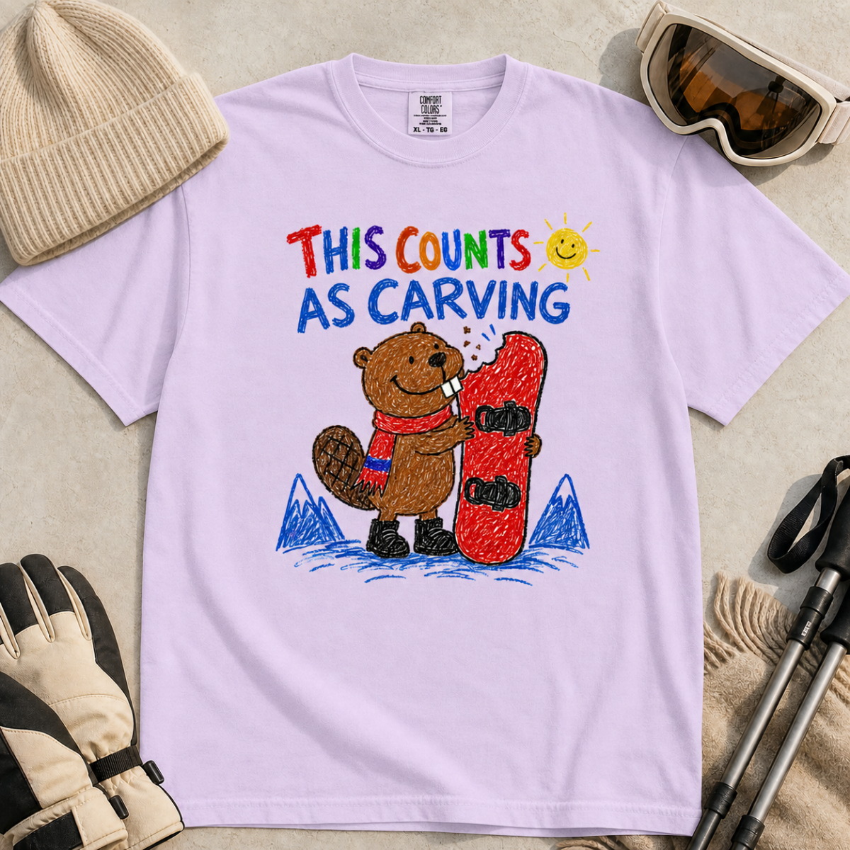 Flat lay of an orchid t-shirt with a playful beaver snowboarding design showing the animal chewing a board beneath “This Counts as Carving” text.