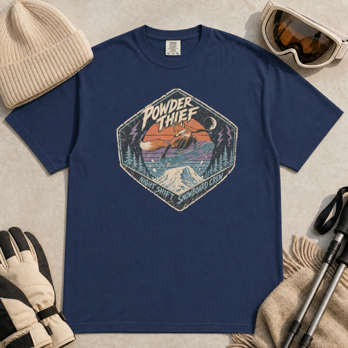Navy blue t-shirt featuring a distressed retro fox snowboarder jumping over a snowy mountain beneath “Powder Thief” lettering.
