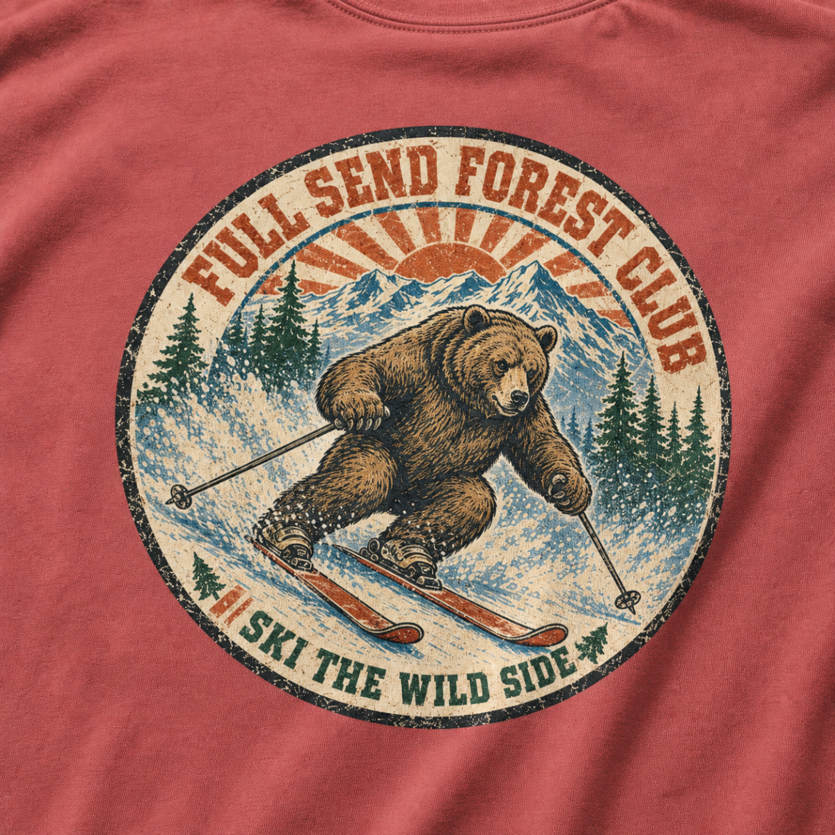 Close-up of a distressed vintage-style bear skiing through snowy mountains with “Full Send Forest Club” and “Ski the Wild Side” lettering.