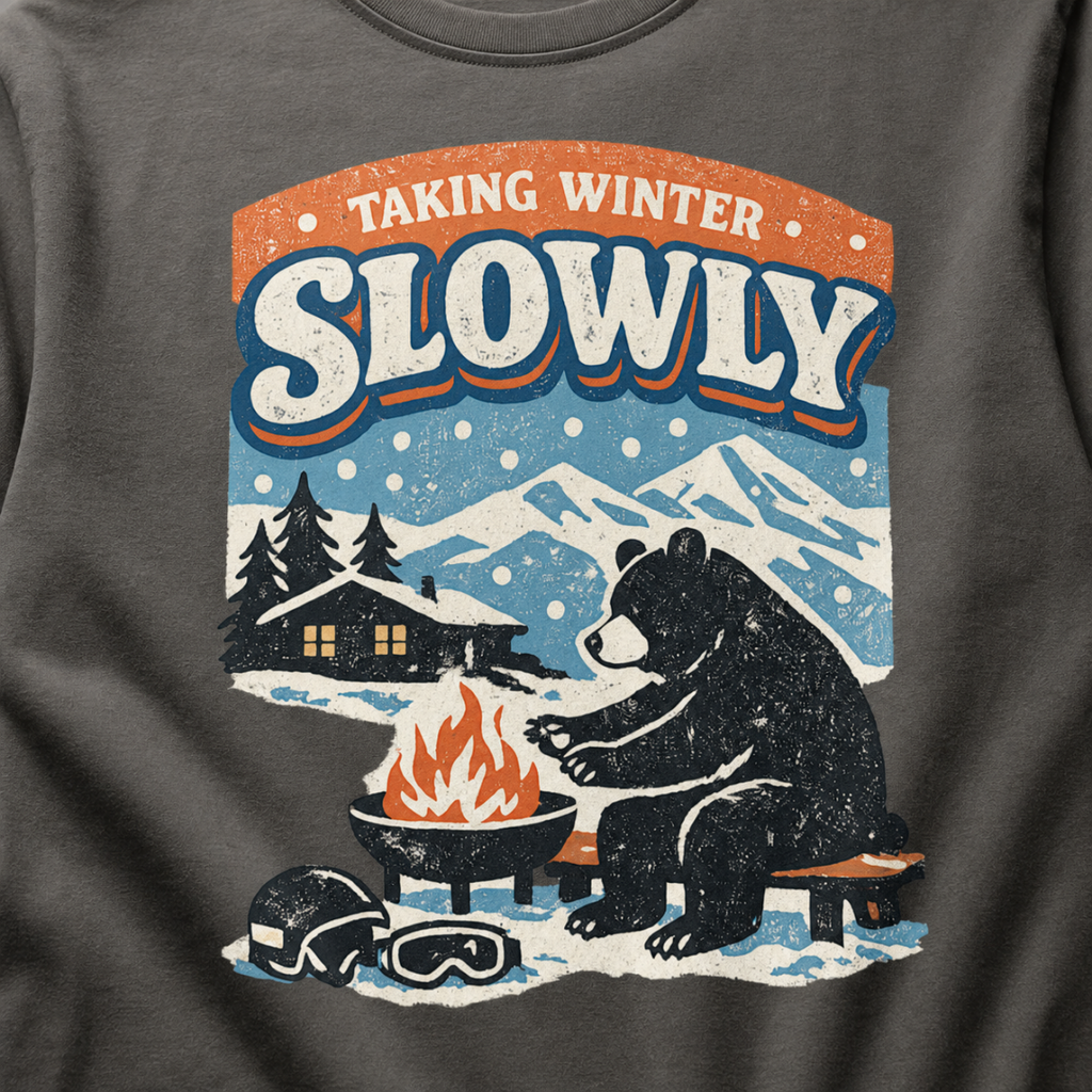 Close-up of a bear sitting beside a winter fire with snowy mountains, a cabin, helmet and goggles.