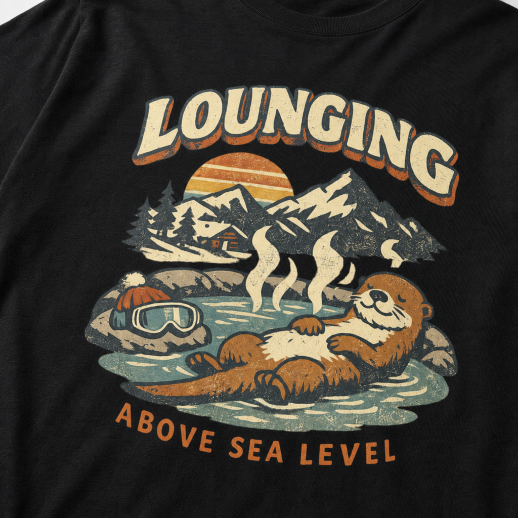 Close-up of a vintage otter hot spring design with snowy mountains, a sunset and the words “Lounging Above Sea Level.”