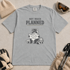 Granite gray t-shirt featuring a raccoon in ski goggles sitting on a bench and studying a trail map, with the words “Not Much Planned.”