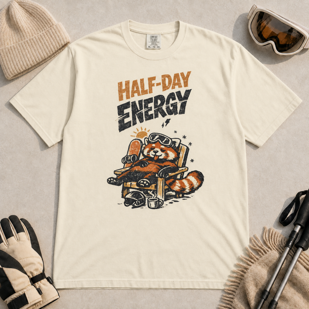 Ivory white t-shirt featuring a relaxed red panda in a chair beside a helmet and mug with the phrase “Half-Day Energy.”