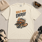 Ivory white t-shirt featuring a relaxed red panda in a chair beside a helmet and mug with the phrase “Half-Day Energy.”