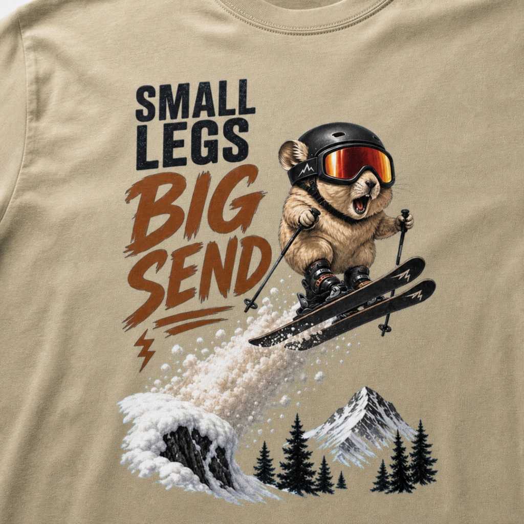 Close-up of a pika performing an airborne ski jump above snowy mountains and trees with the phrase “Small Legs Big Send.”