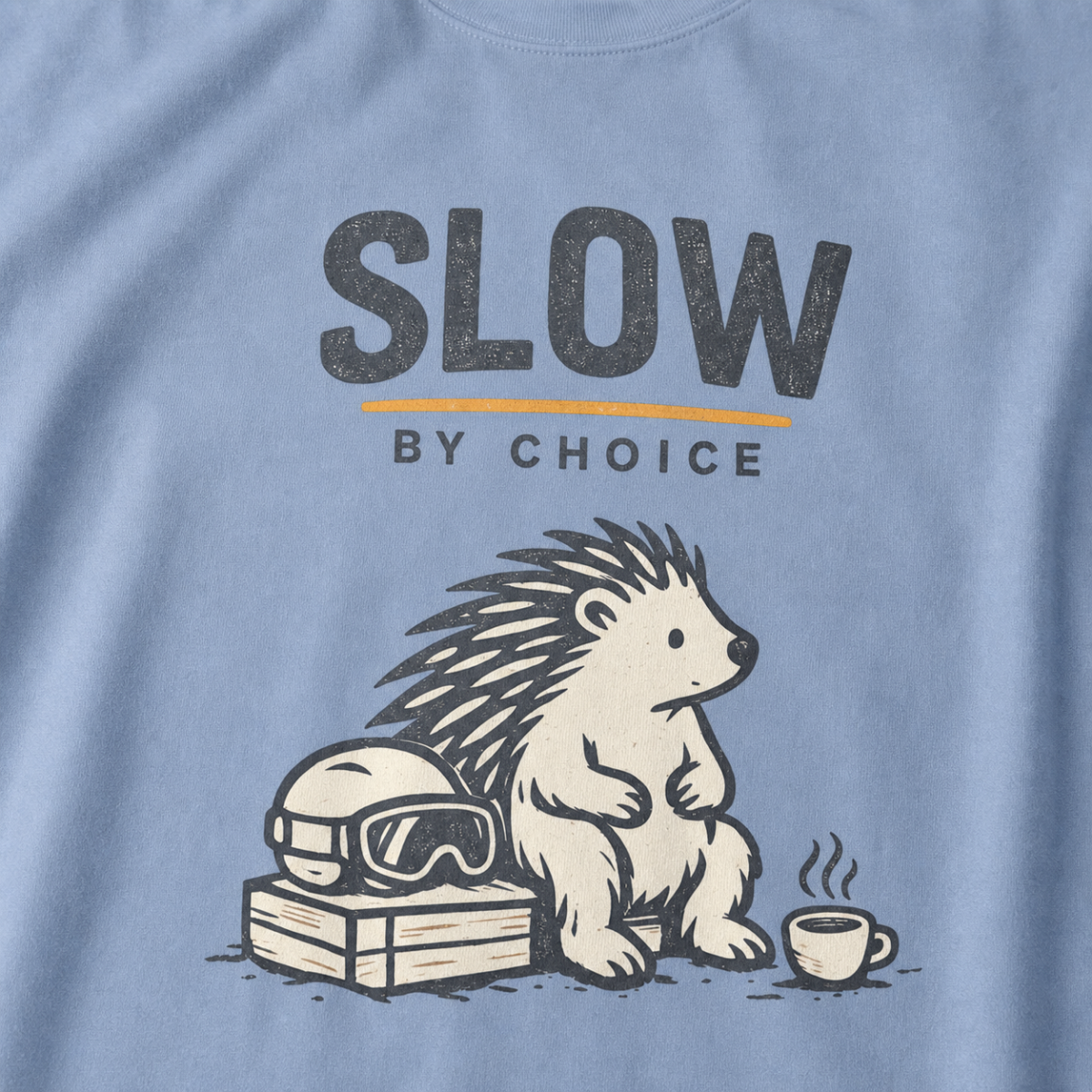 Close-up of a seated hedgehog resting beside ski goggles and a steaming mug under “Slow by Choice” lettering.