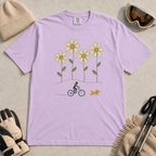 Orchid purple t-shirt featuring a small female mountain biker and yellow dog beneath four oversized daisies.