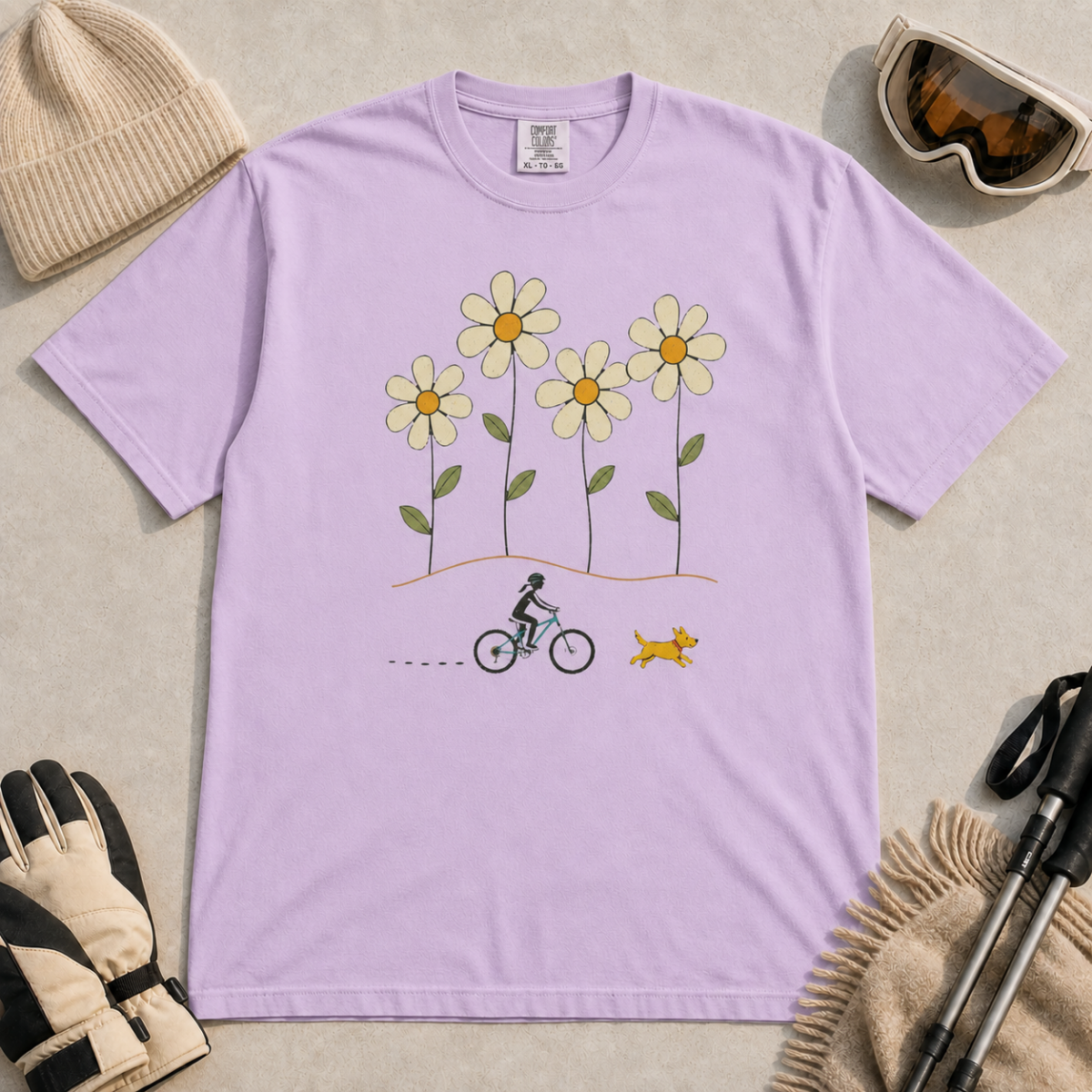 Orchid purple t-shirt featuring a small female mountain biker and yellow dog beneath four oversized daisies.
