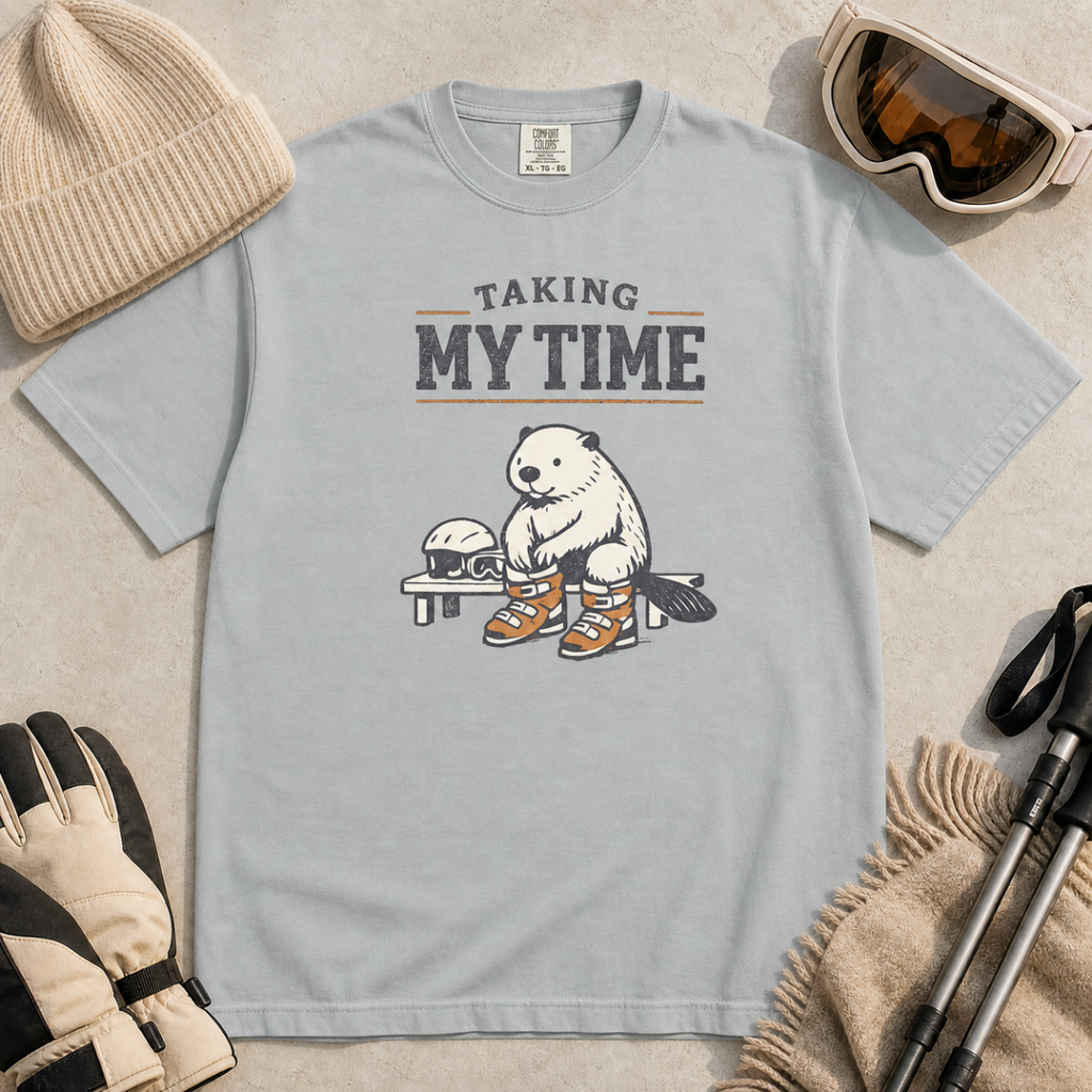 Granite gray t-shirt featuring a beaver seated on a bench fastening snowboard boots beneath “Taking My Time” text.