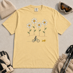 Butter yellow t-shirt featuring a small female mountain biker and yellow dog beneath four oversized daisies.