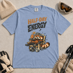 Washed denim blue t-shirt featuring a relaxed red panda in a chair beside a helmet and mug with the phrase “Half-Day Energy.”