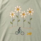 Close-up of a female mountain biker riding beside a yellow dog beneath four large hand-drawn daisies.