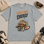 Granite gray t-shirt featuring a relaxed red panda in a chair beside a helmet and mug with the phrase “Half-Day Energy.”
