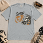 Granite gray t-shirt featuring a relaxed hedgehog in a chair with a hot drink and snowboard beneath “Slopes? Maybe Later.” text.