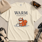 Ivory white t-shirt featuring a bundled-up squirrel warming its paws beside a steaming mug under “Warm Eventually” text.