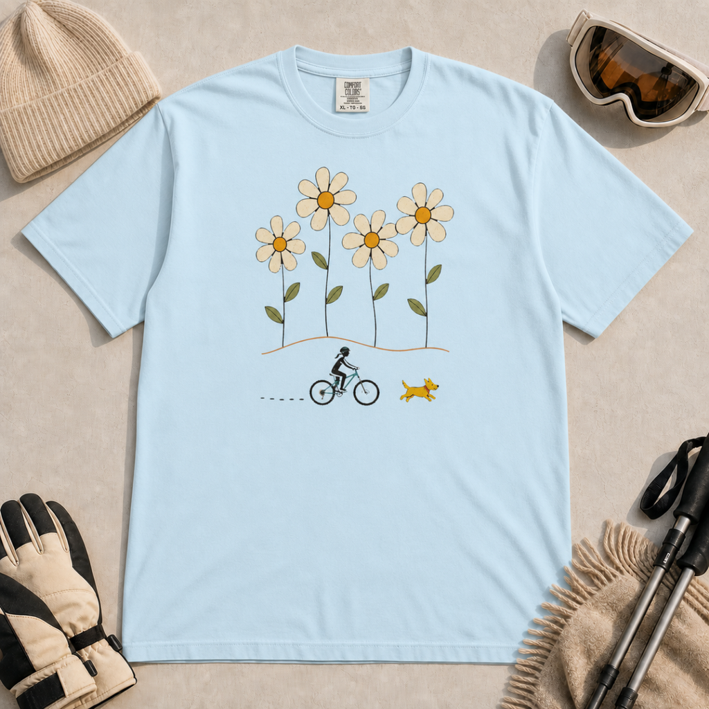 Chambray blue t-shirt featuring a small female mountain biker and yellow dog beneath four oversized daisies.