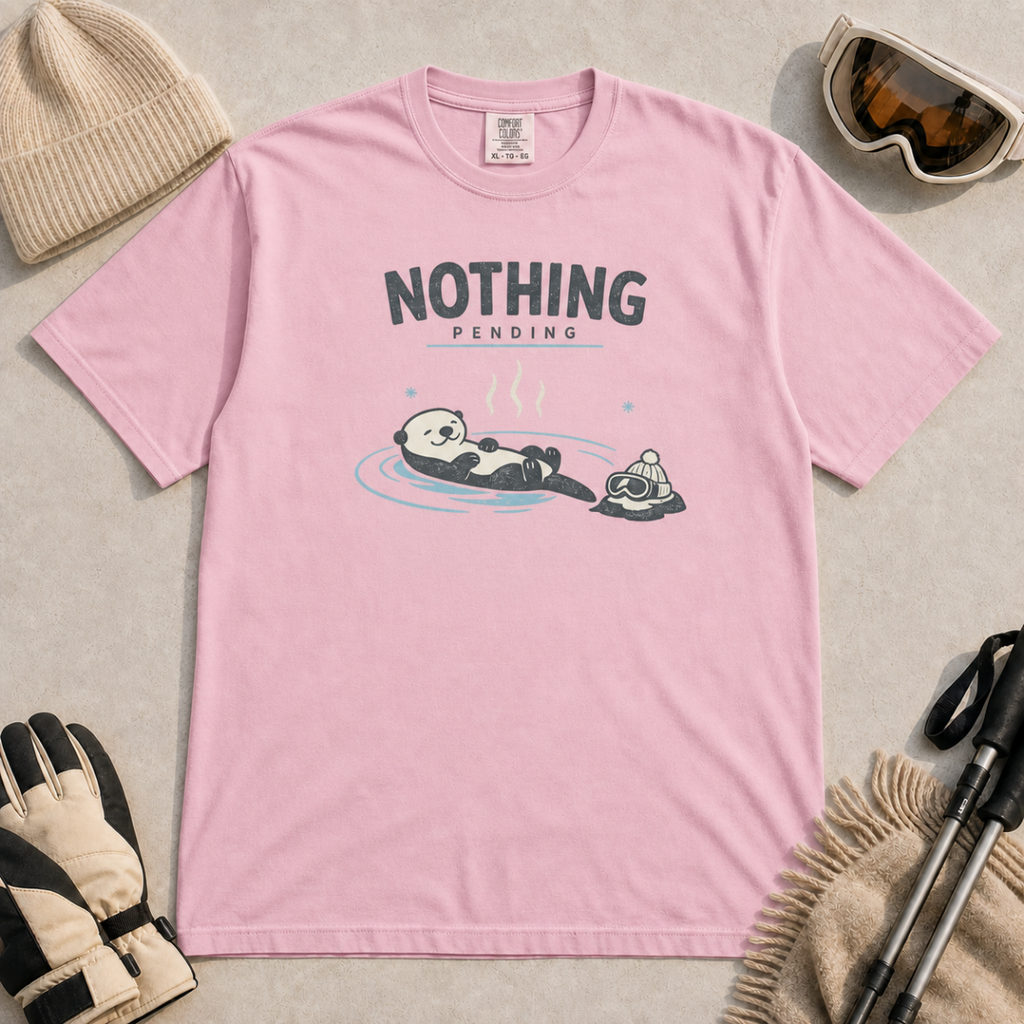 Blossom pink t-shirt featuring a relaxed otter floating in a hot spring beside winter goggles and a beanie, with the words “Nothing Pending.”