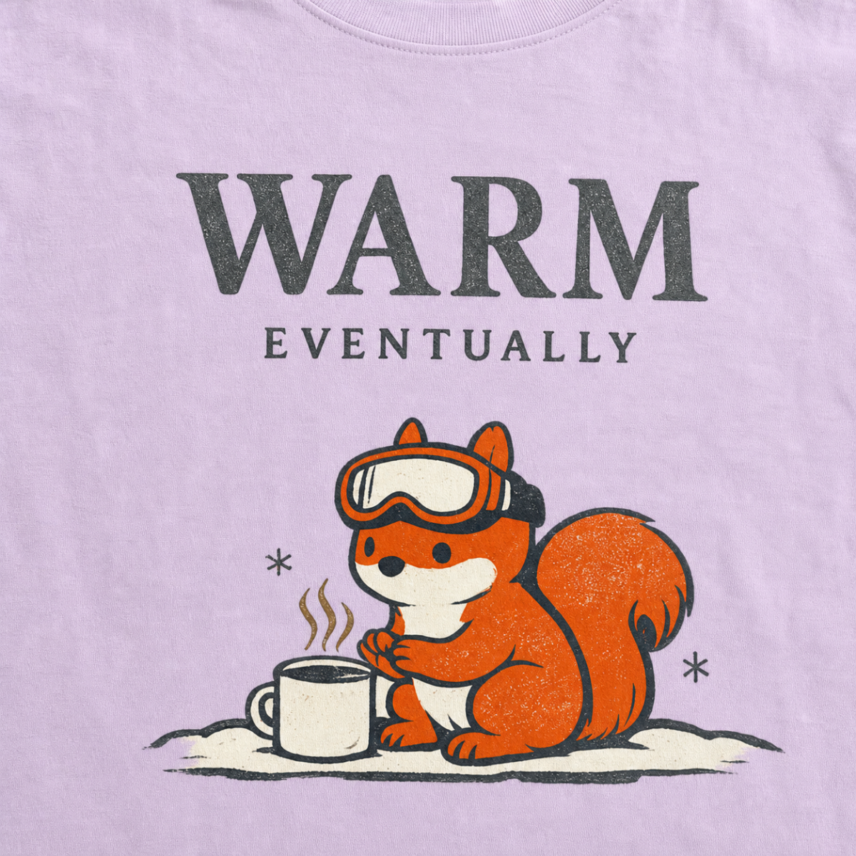Close-up of an orchid purple t-shirt design showing a ski-goggle-wearing squirrel beside a hot drink under “Warm Eventually” text.