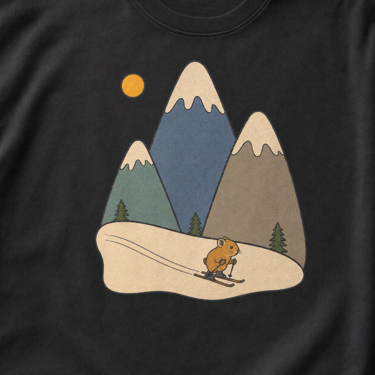 Close-up of a black t-shirt featuring three muted snow-capped mountains, pine trees, a golden sun and a tiny animal skiing downhill.