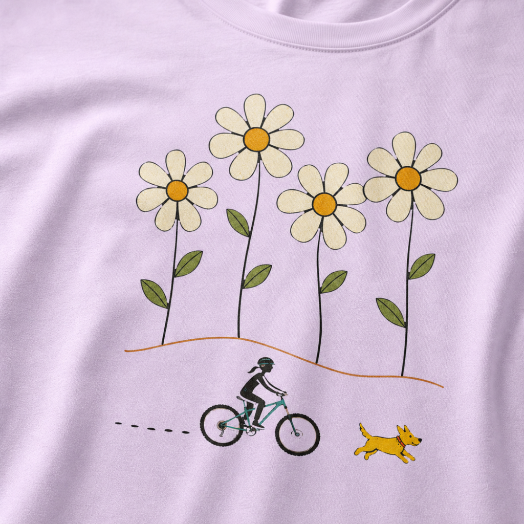 Close-up of a female mountain biker riding beside a yellow dog beneath four large hand-drawn daisies.