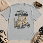 Granite gray t-shirt featuring a marmot with skiing, snowboarding, and mountain biking gear under “Conditions Are Perfectly Questionable” text.