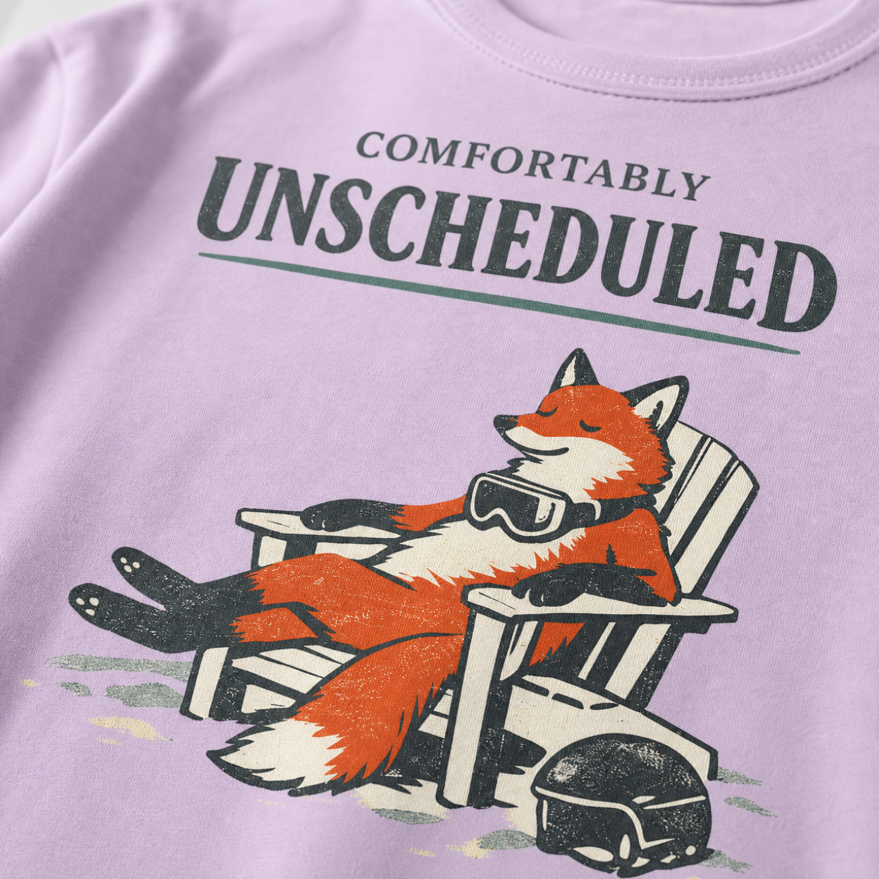 Close-up of a relaxed fox wearing ski goggles in a chair with the words “Comfortably Unscheduled.”